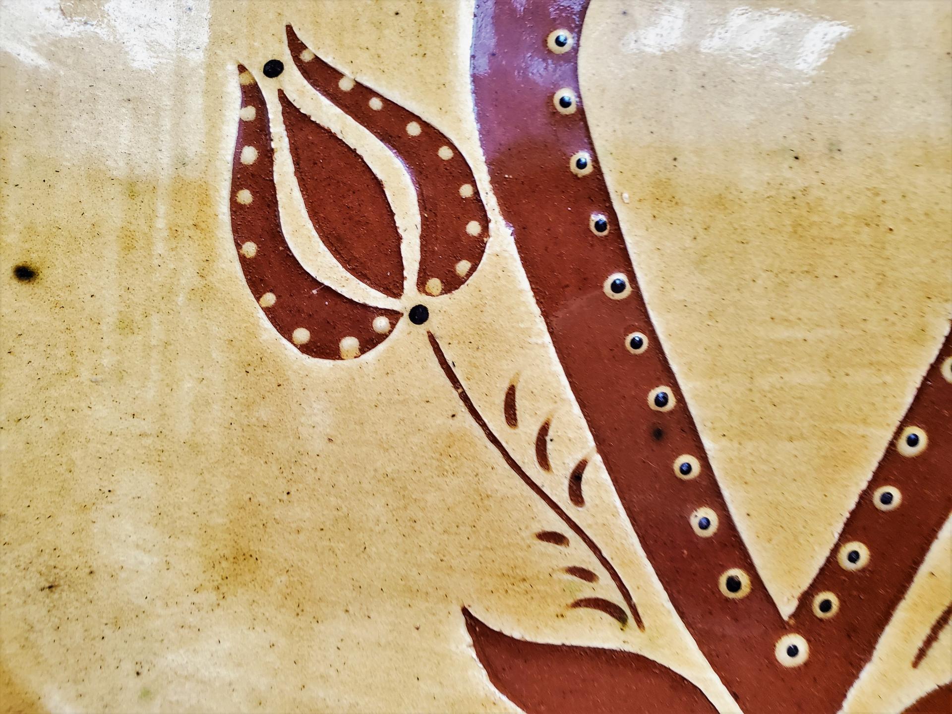 Redware Platter with Heart, Tulips and Leaves Sgraffito Decoration, detail