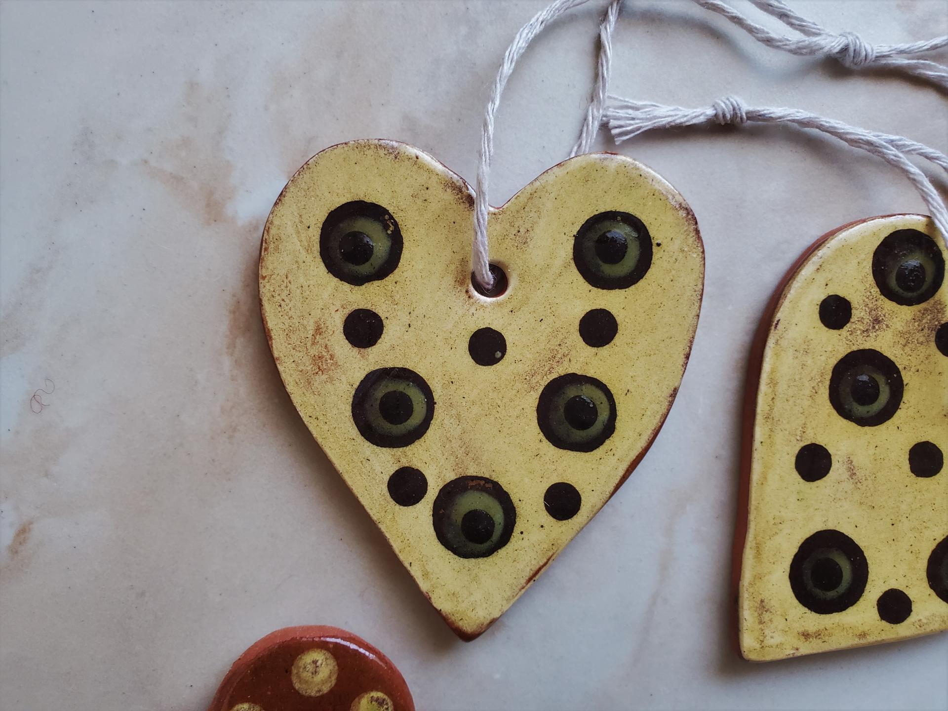 Set of Two Heart-Shaped Redware Ornaments with Green and Black Polka Dots Slip Decoration