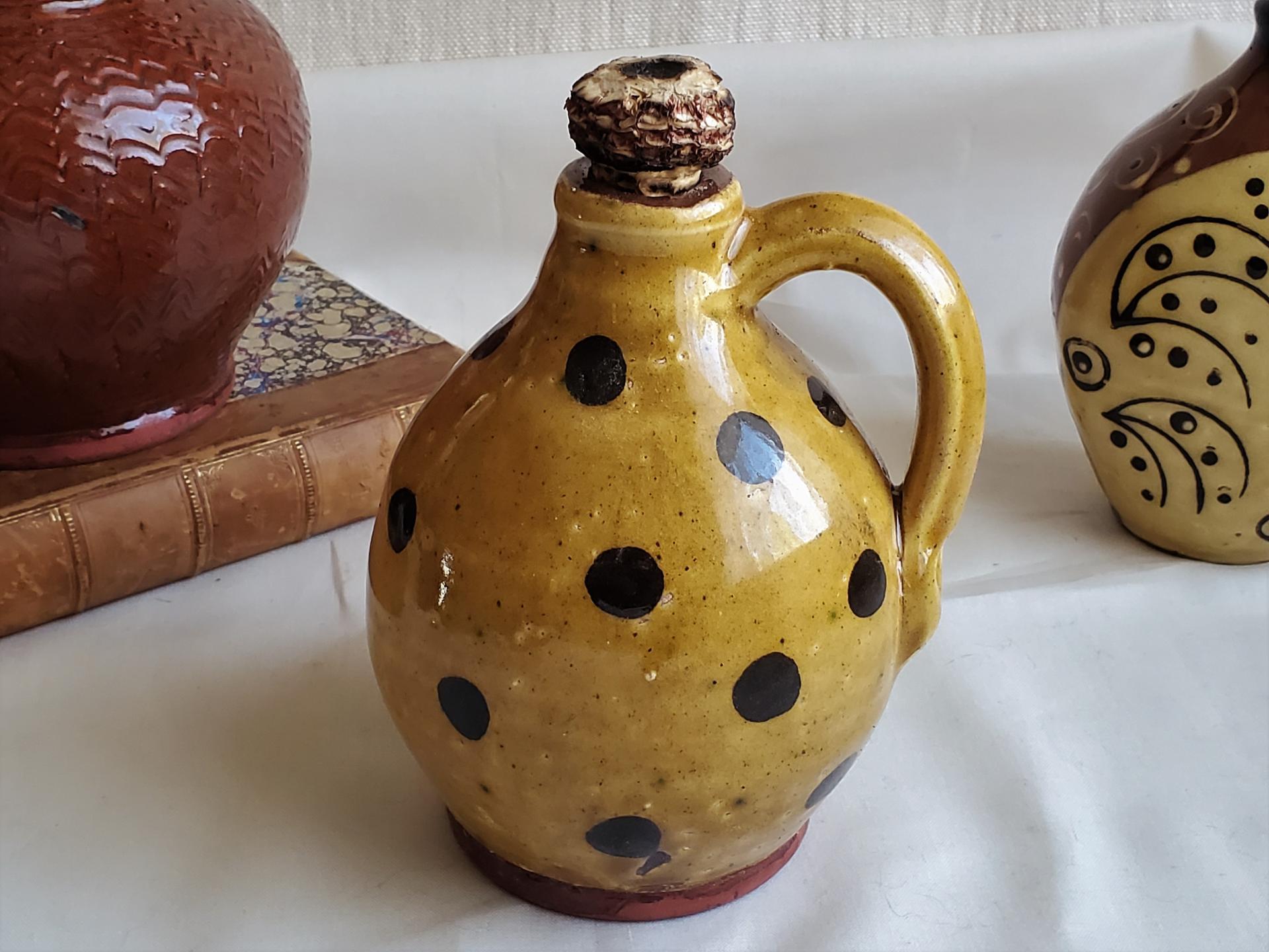 Redware Jug with Black Dots and Corn Cob Stopper