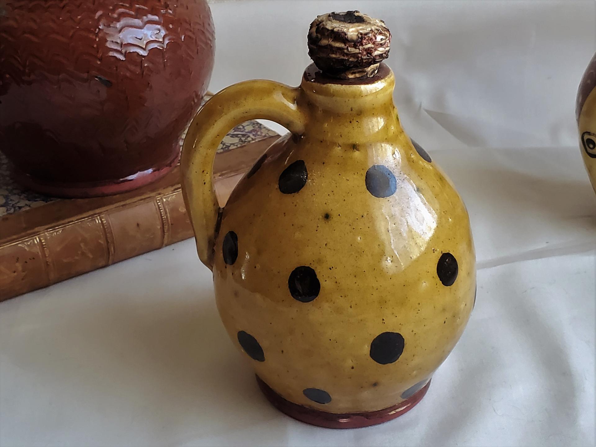 Redware Jug with Black Dots and Corn Cob Stopper