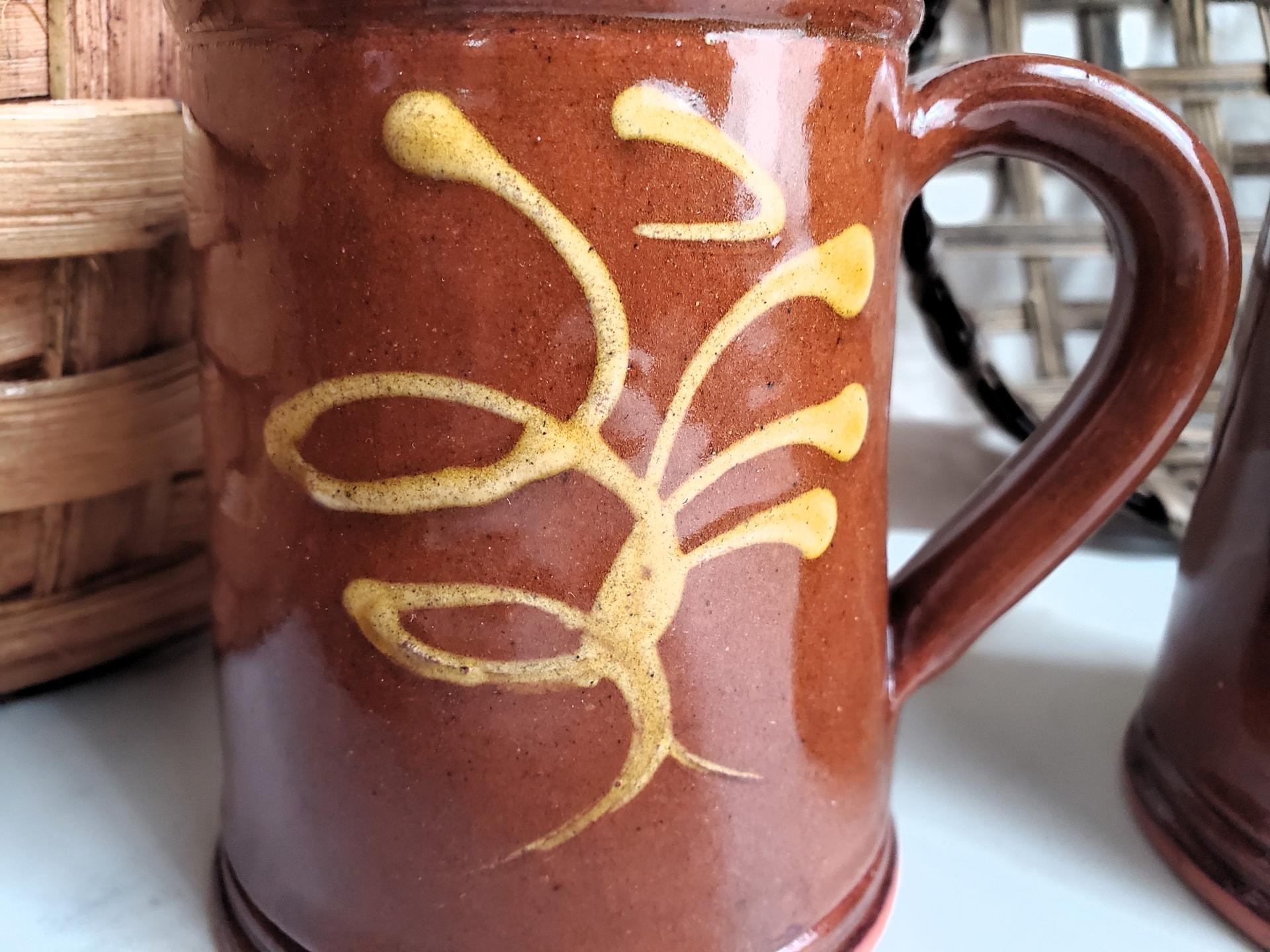 Two Slip-Decorated Redware Mugs with Feather Motif (a)