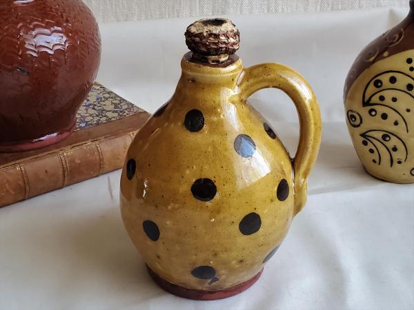Redware Jug with Black Dots and Corn Cob Stopper